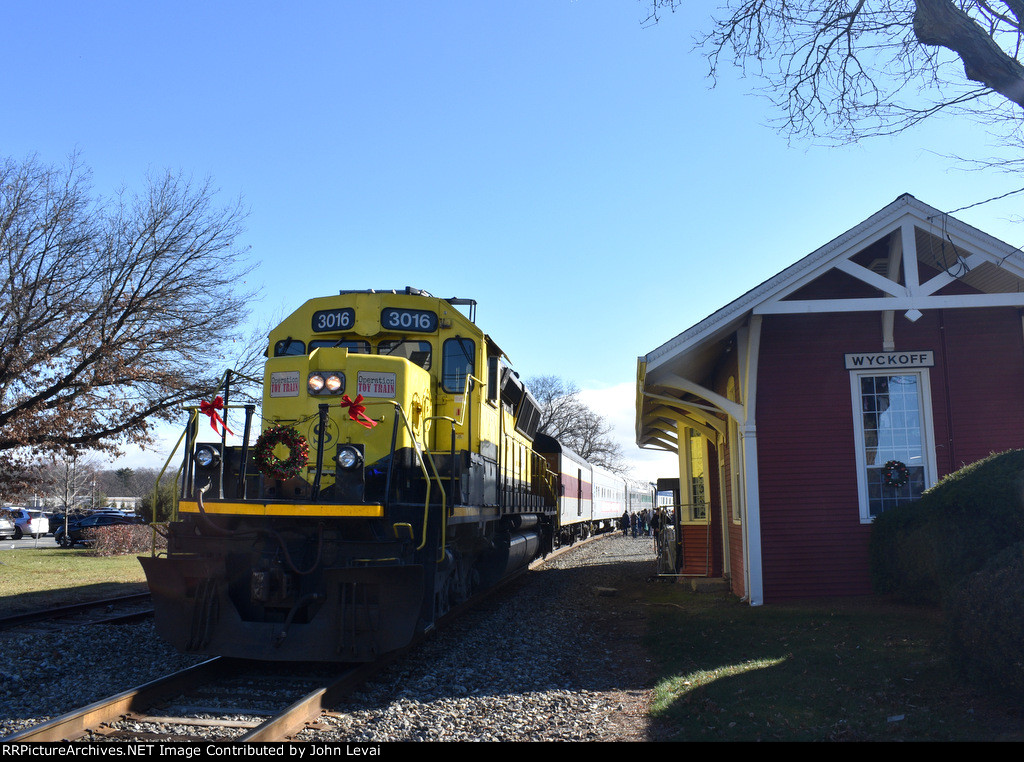 The 3016 rests with its train at the restored Wyckoff Station